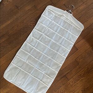 Double-Sided Jewelry Organizer with 80 Clear Pockets hangs in closet